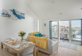 Coastal blues, fresh whites and soft grey interiors lend themselves to deep relaxation in this open plan living and dining area.