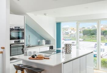 There are plenty of seating options to enjoy time with loved ones at the breakfast bar or dining table in this open plan relaxed area. 