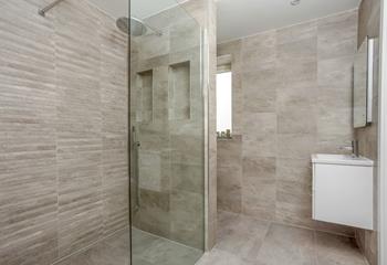 The ground floor en suite is a spacious wet room with shower, WC and basin.