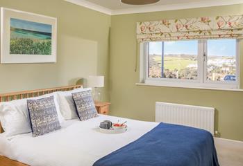 With countryside and ocean hues, the second double bedroom is a relaxing retreat.