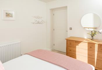 The pink hues are in the first of two dreamy double bedrooms on the ground floor.