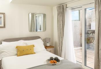 The second ground floor bedroom boasts direct access to the garden and has calming touches of nature throughout.