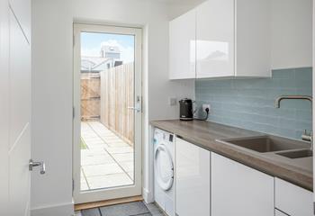 The utility room has a washing machine and a tumble dryer.