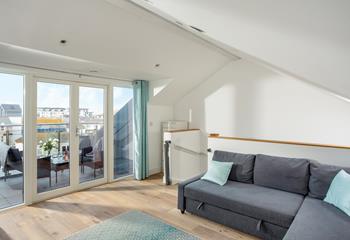 The sunroom has doors out to a balcony where you can enjoy al fresco dining.