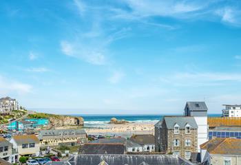 Views across the rooftops reveal the iconic Chapel Rock on Perranporth beach.