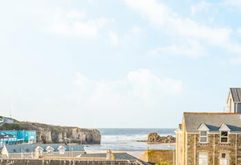 The beautiful view looks across the beach to Chapel Rock sea pool.