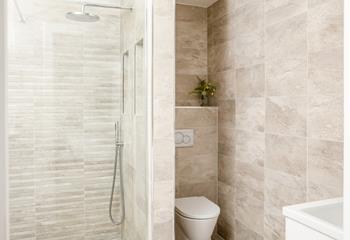 The ground floor en suite has a blissful rainfall shower.