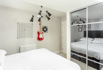 A music-themed bedroom! Great for teenagers, with a guitar and musical artwork.