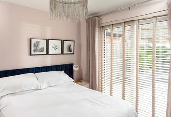 The elegant double bedroom has patio doors to the garden, so you can open the doors to a Cornish sunrise in the mornings.