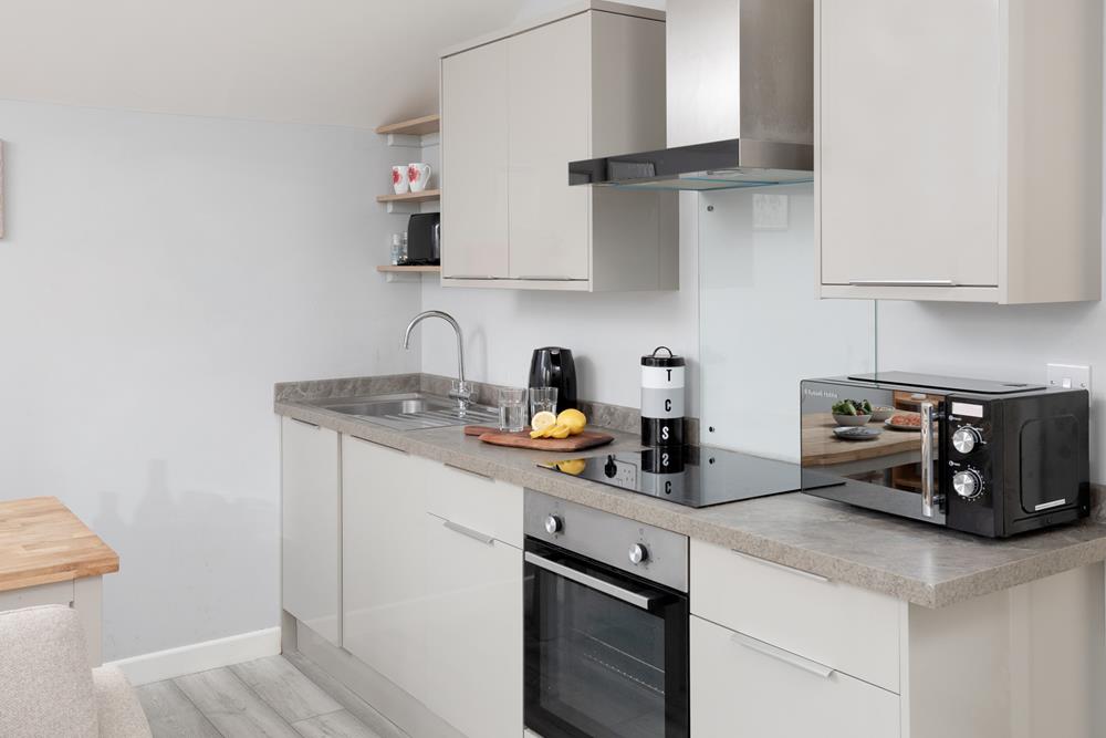 Compact and modern, the kitchen area has all the amenities you need.