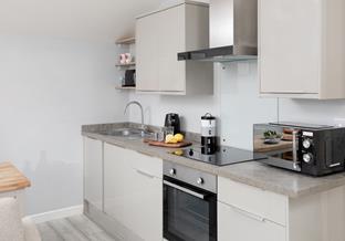 Compact and modern, the kitchen area has all the amenities you need.