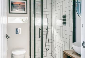 Wash away sandy days in the modern bathroom, complete with handheld and rainfall shower heads.