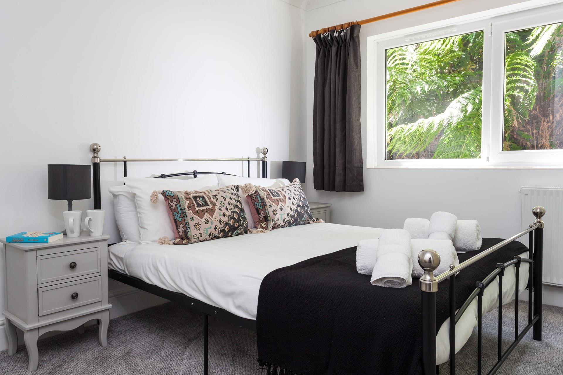 Bedroom 1 has a spacious double bed to settle into after a day on the beach.