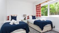 Bedroom 2 has twin beds perfect for adults or children to drift into a dreamy night's sleep after jam-packed days.