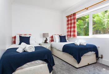 Bedroom 2 has twin beds perfect for adults or children to drift into a dreamy night's sleep after jam-packed days.