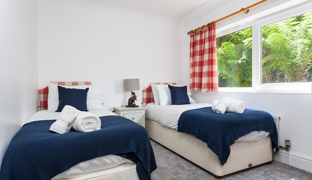 Bedroom 2 has twin beds perfect for adults or children to drift into a dreamy night's sleep after jam-packed days.