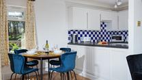 The stylish dining table is the perfect space to enjoy time together over delicious meals.