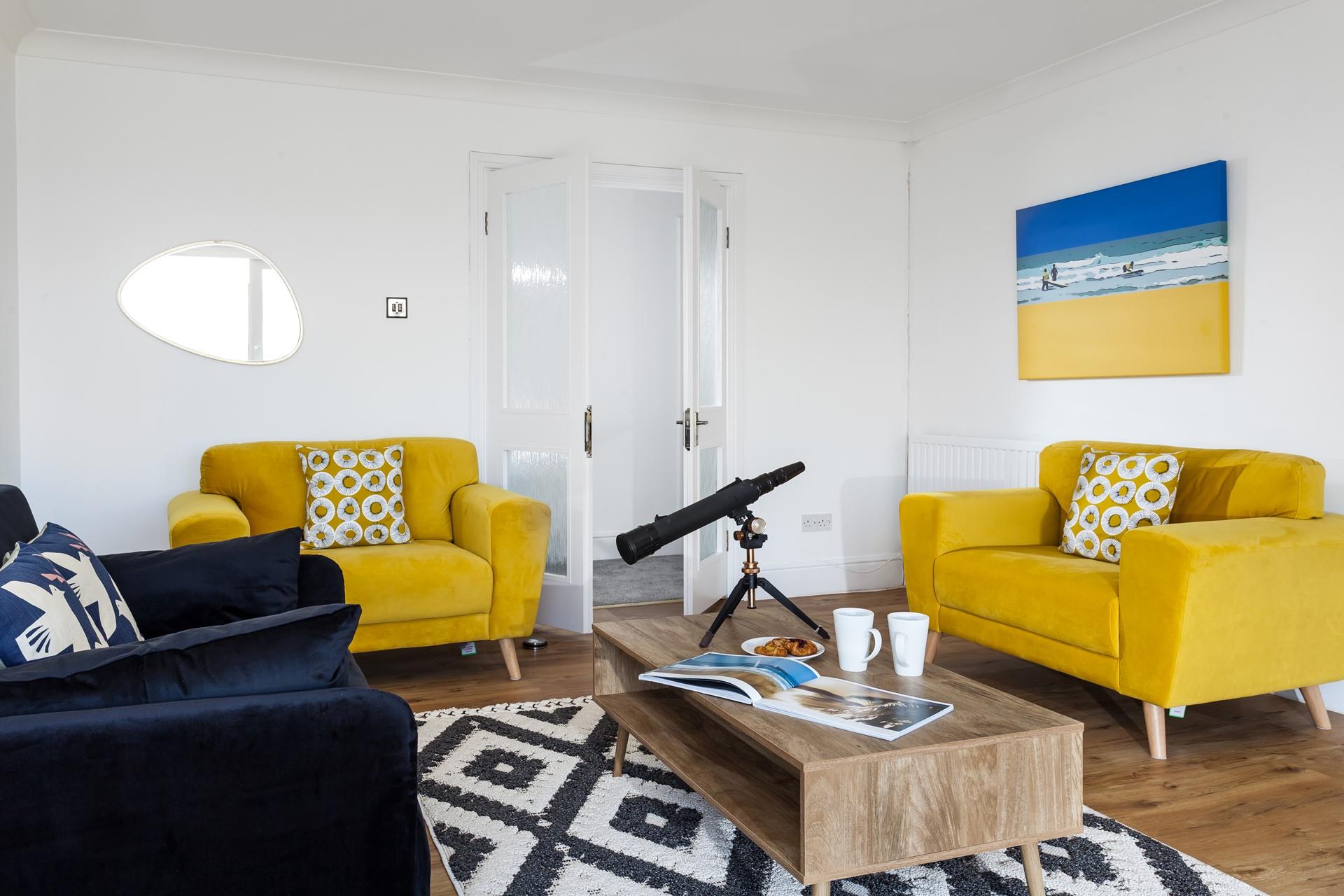 The sitting room is decorated with pops of colour creating a bright and airy space to relax.