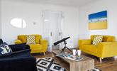 The sitting room is decorated with pops of colour creating a bright and airy space to relax. - Thumbnail Image