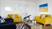The sitting room is decorated with pops of colour creating a bright and airy space to relax.