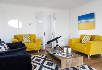 The sitting room is decorated with pops of colour creating a bright and airy space to relax.