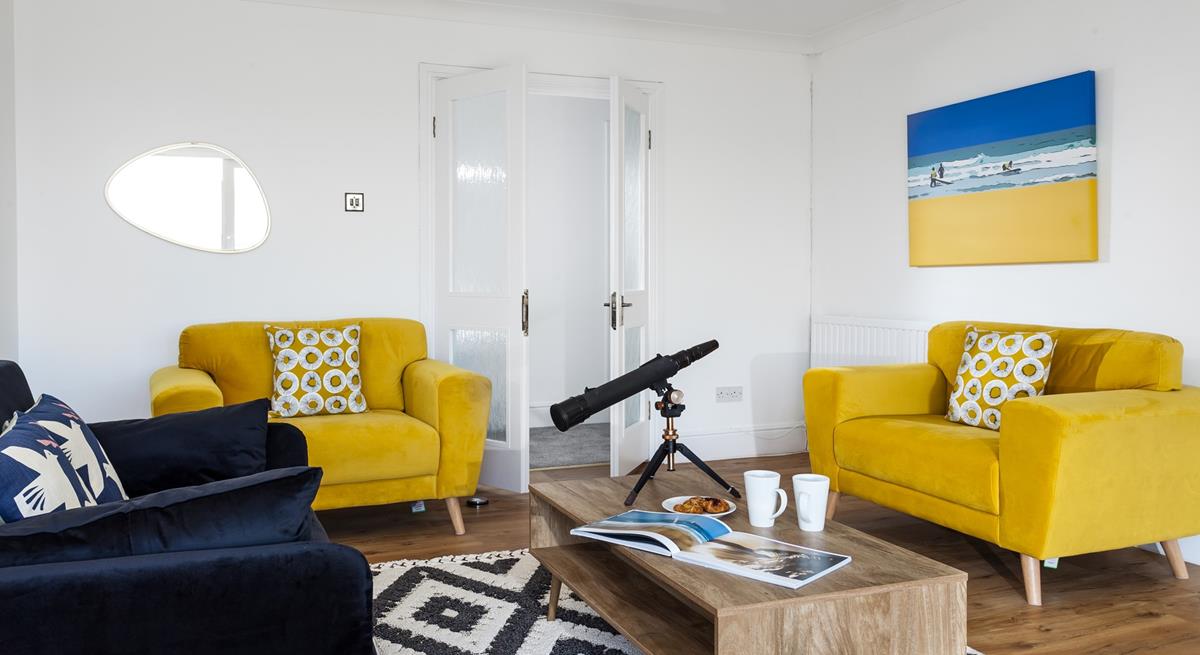 The sitting room is decorated with pops of colour creating a bright and airy space to relax.