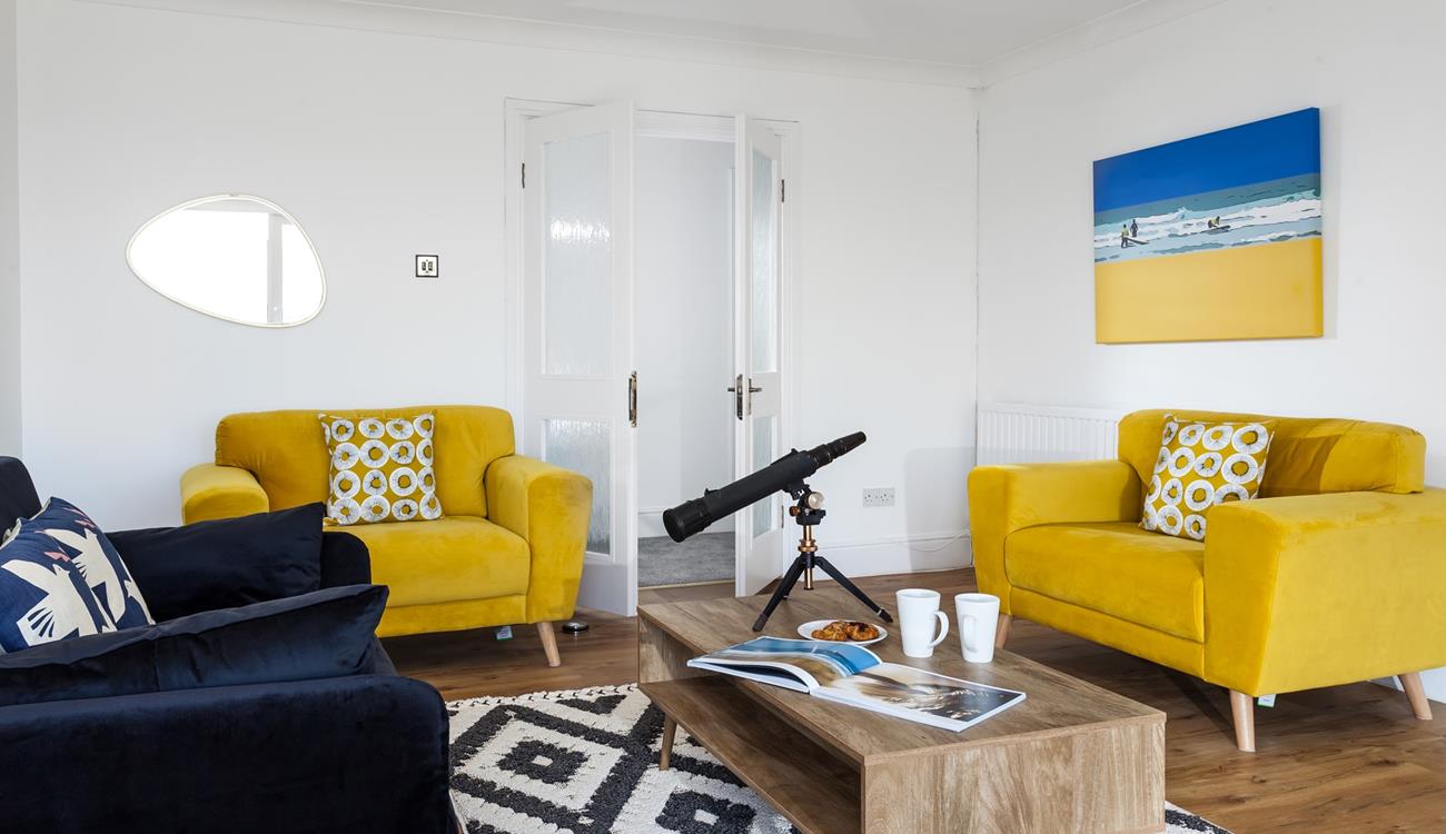 The sitting room is decorated with pops of colour creating a bright and airy space to relax.