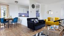 The open plan living space is modern and light to spend time together as a family.