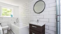 The bathroom has a bath to indulge in after a day walking the coast path.