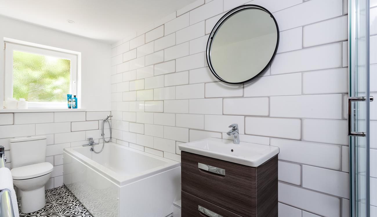 The bathroom has a bath to indulge in after a day walking the coast path.