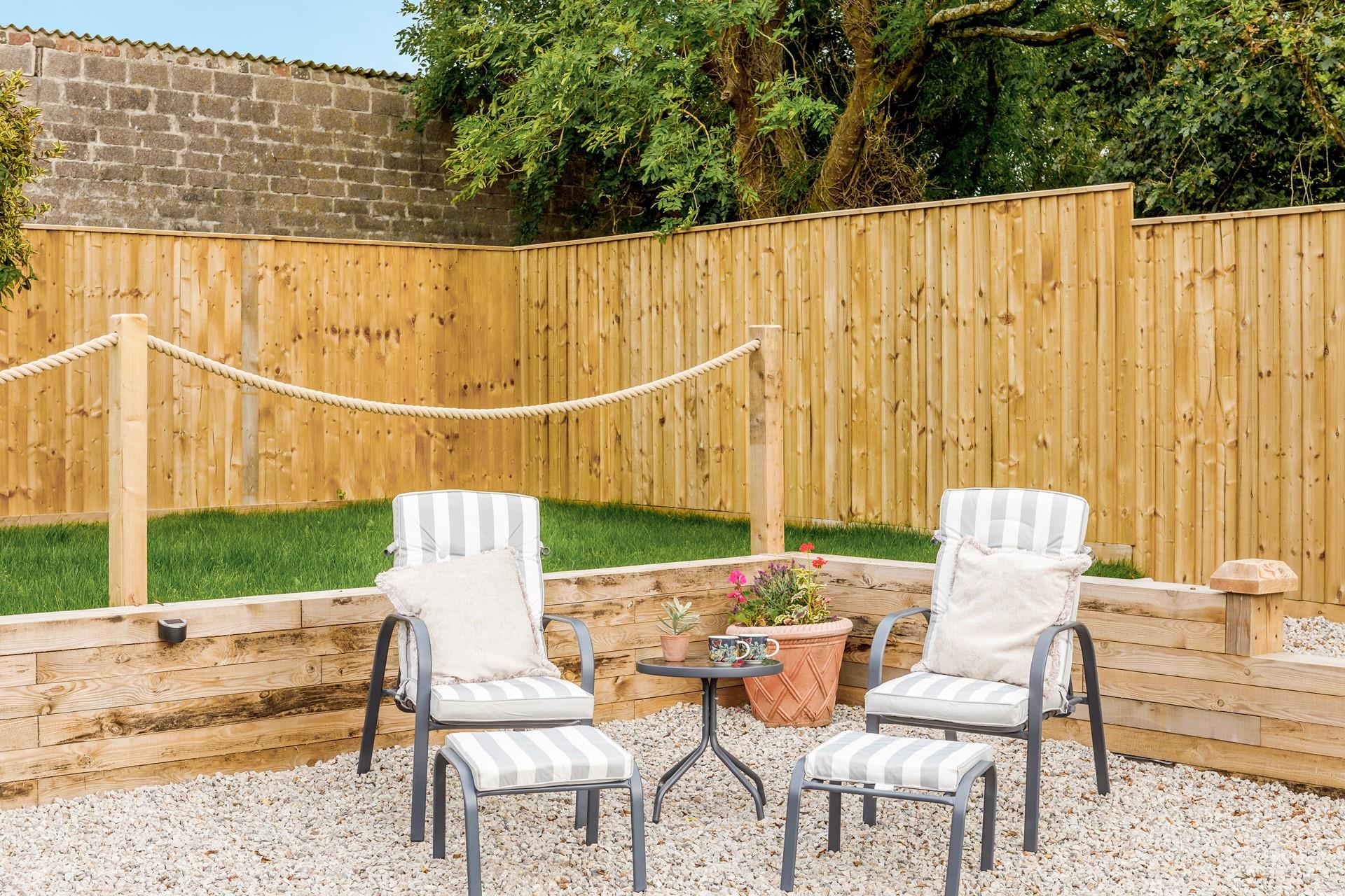 Put your feet up on the garden chairs after a coast path walk.