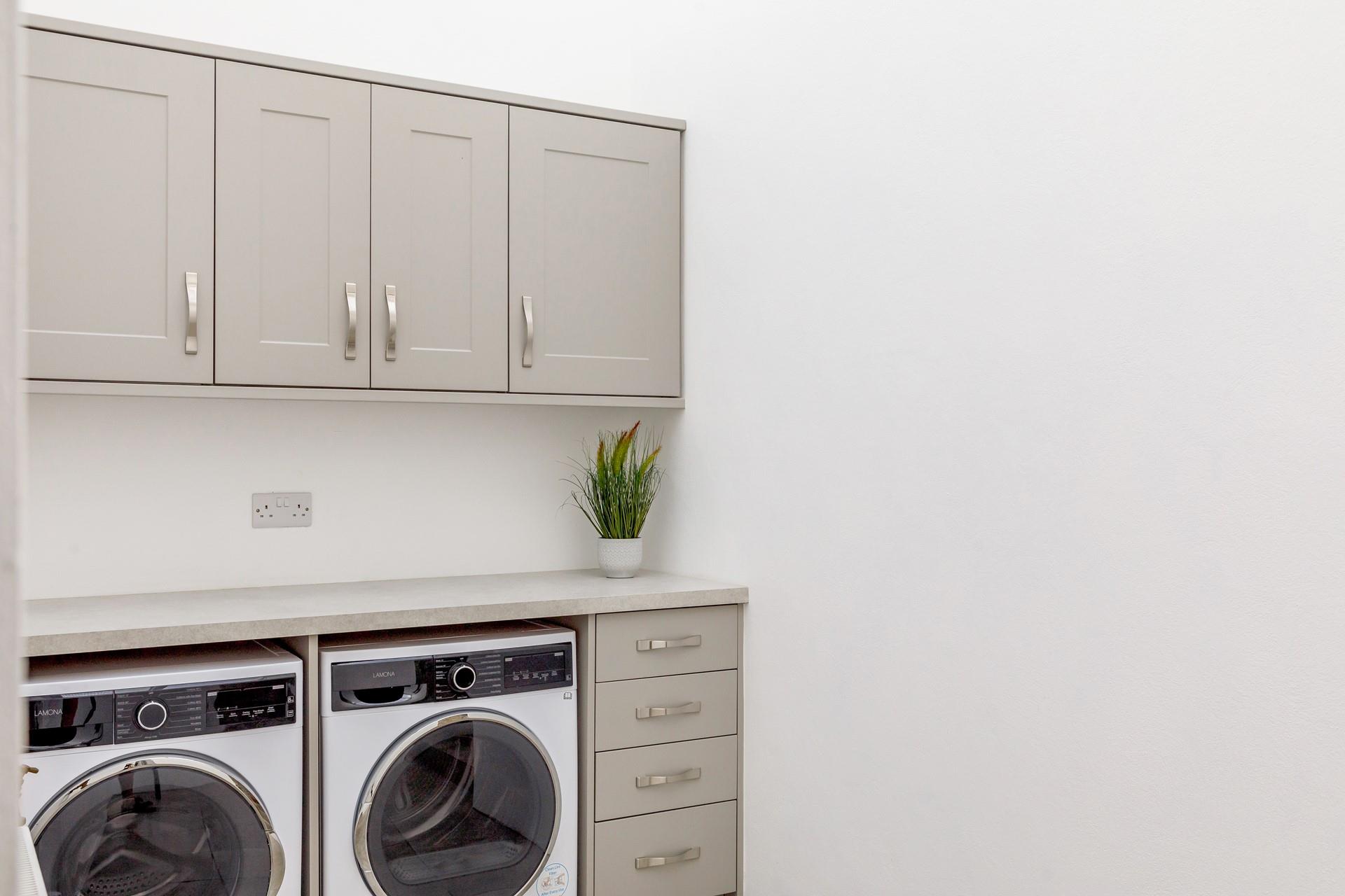 The utility room has a washer and dryer.