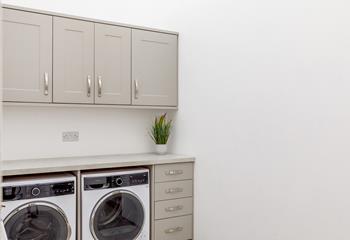 The utility room has a washer and dryer.