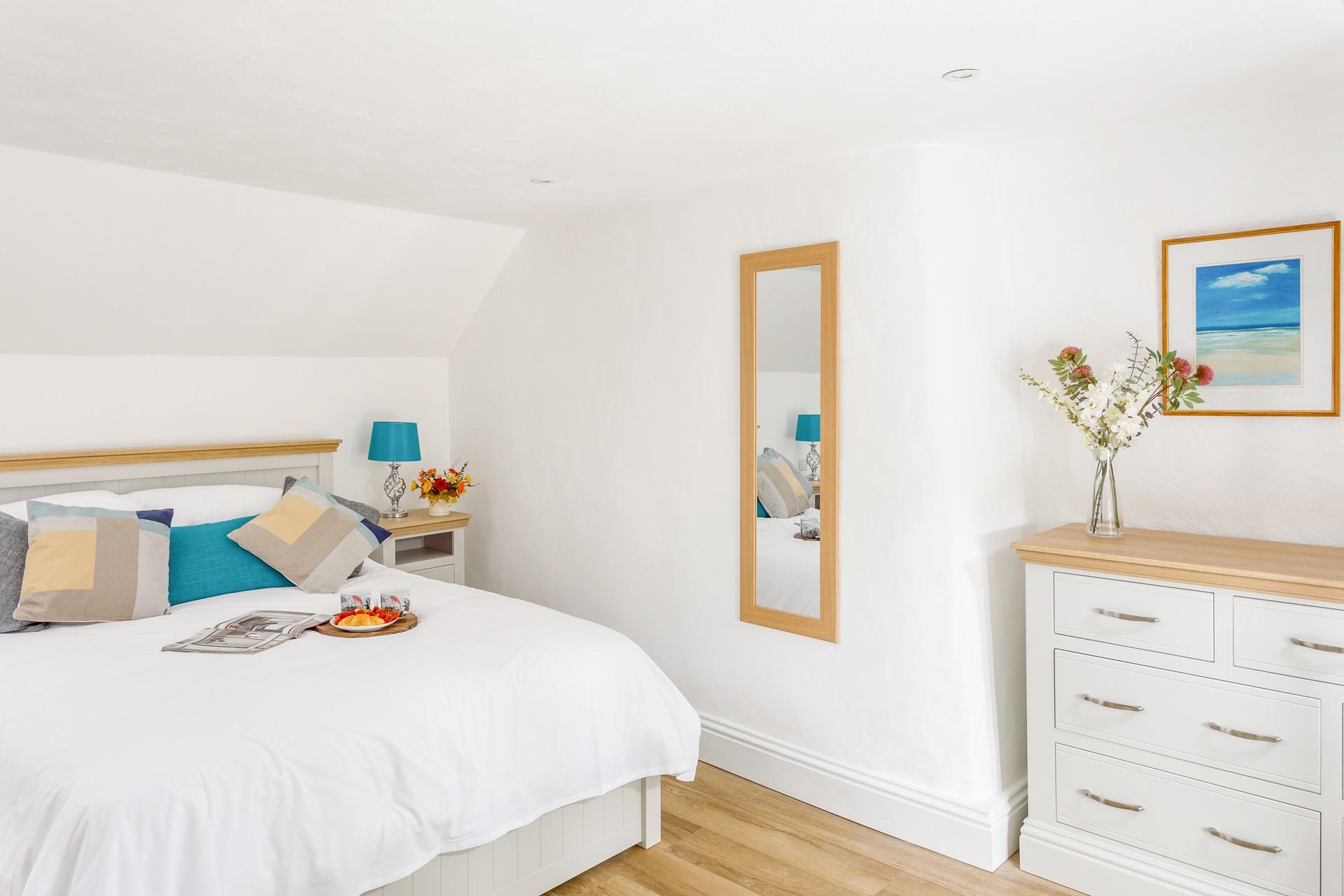 The bedroom is decorated with homely furnishings and interiors.