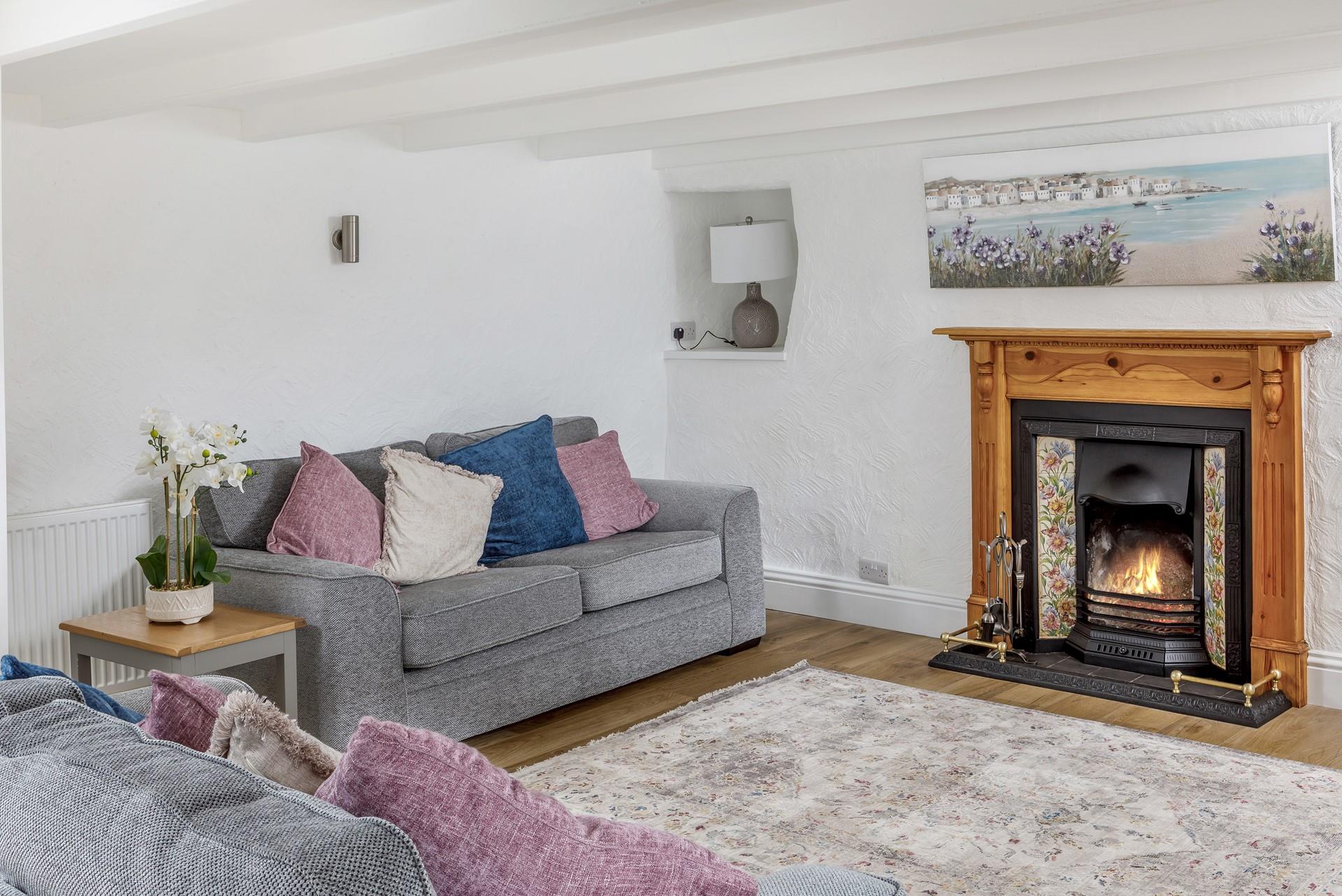 The lovely fireplace makes the sitting room a cosy base to spend evenings.