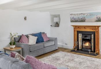 The lovely fireplace makes the sitting room a cosy base to spend evenings.