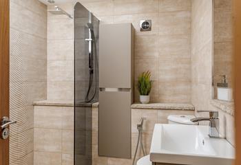 The wet room has a large walk-in shower for getting ready in the mornings.