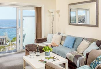 The cosy sitting area has stunning views across Mevagissey harbour.