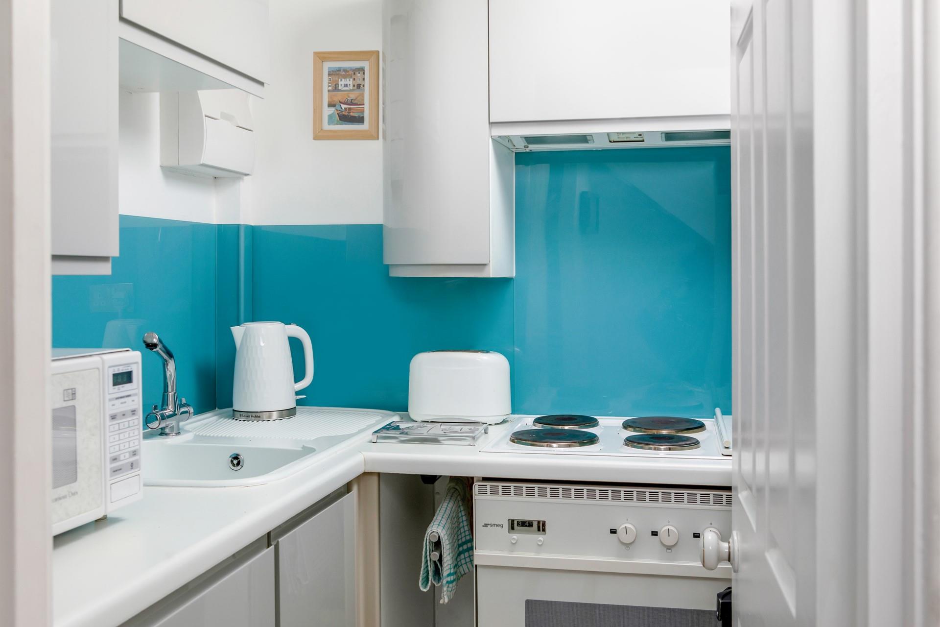 The kitchen has all you need to cook a meal for two.