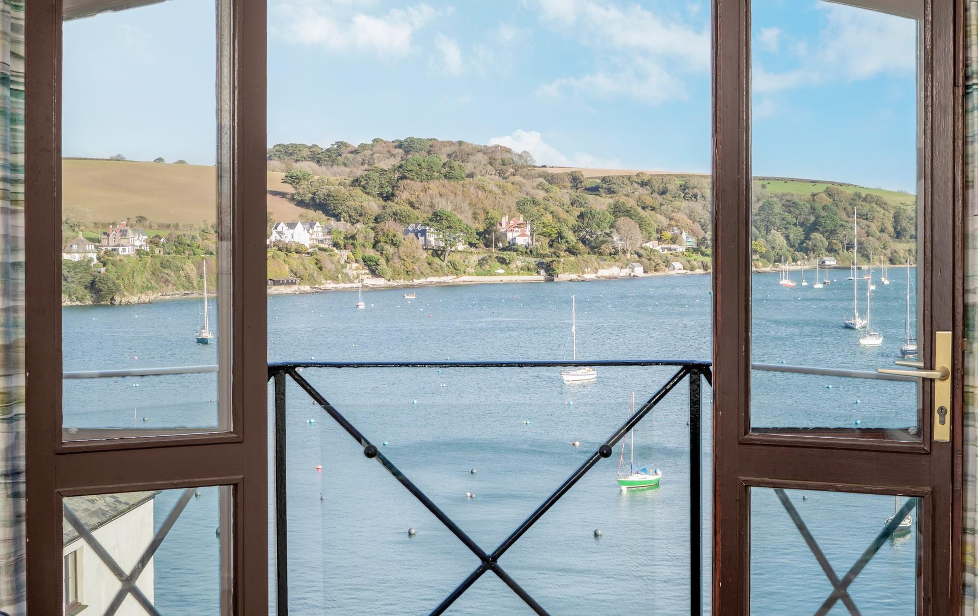 Open the balcony doors and head outside to check the day's weather.