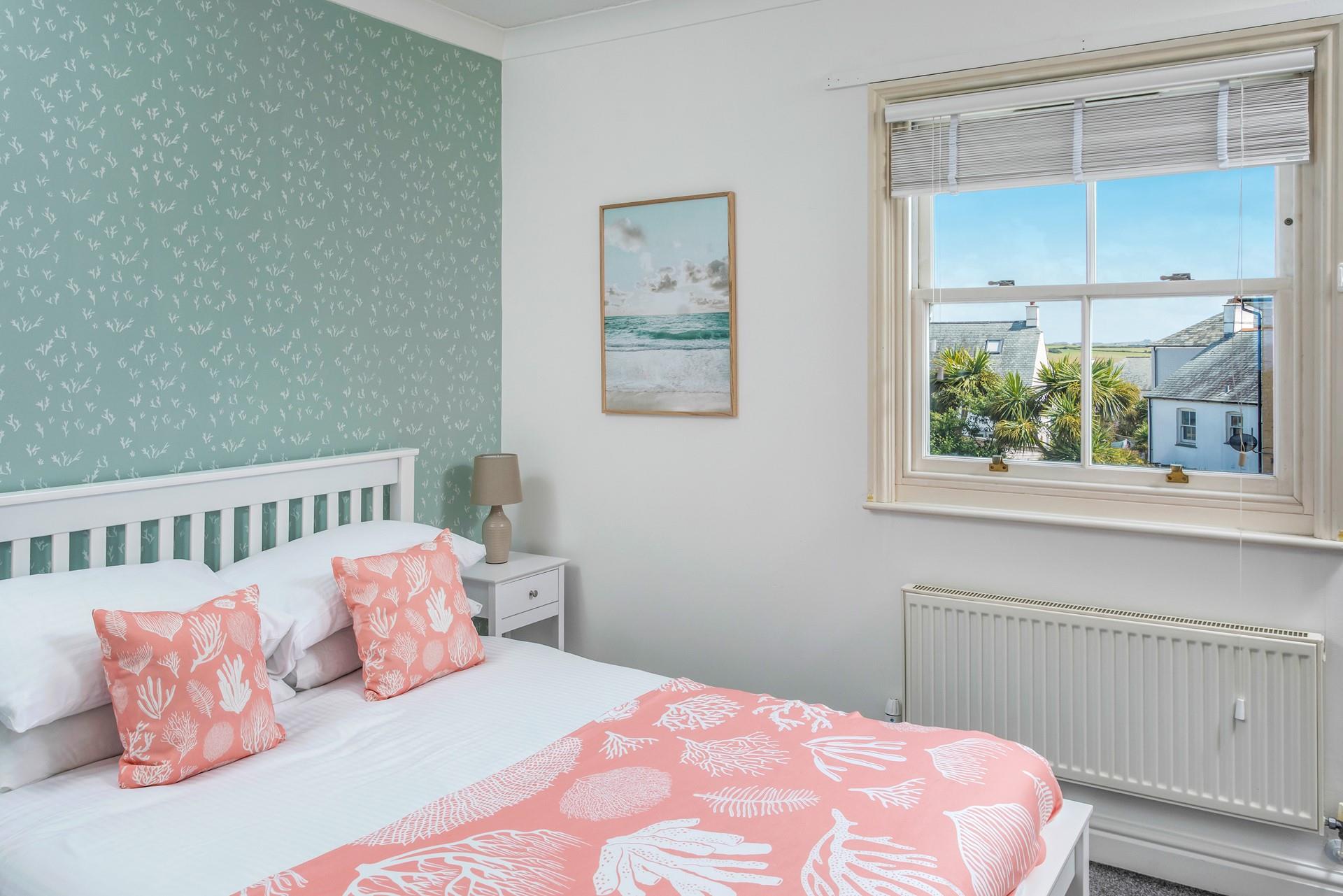 We love the coral theme in the second bedroom.