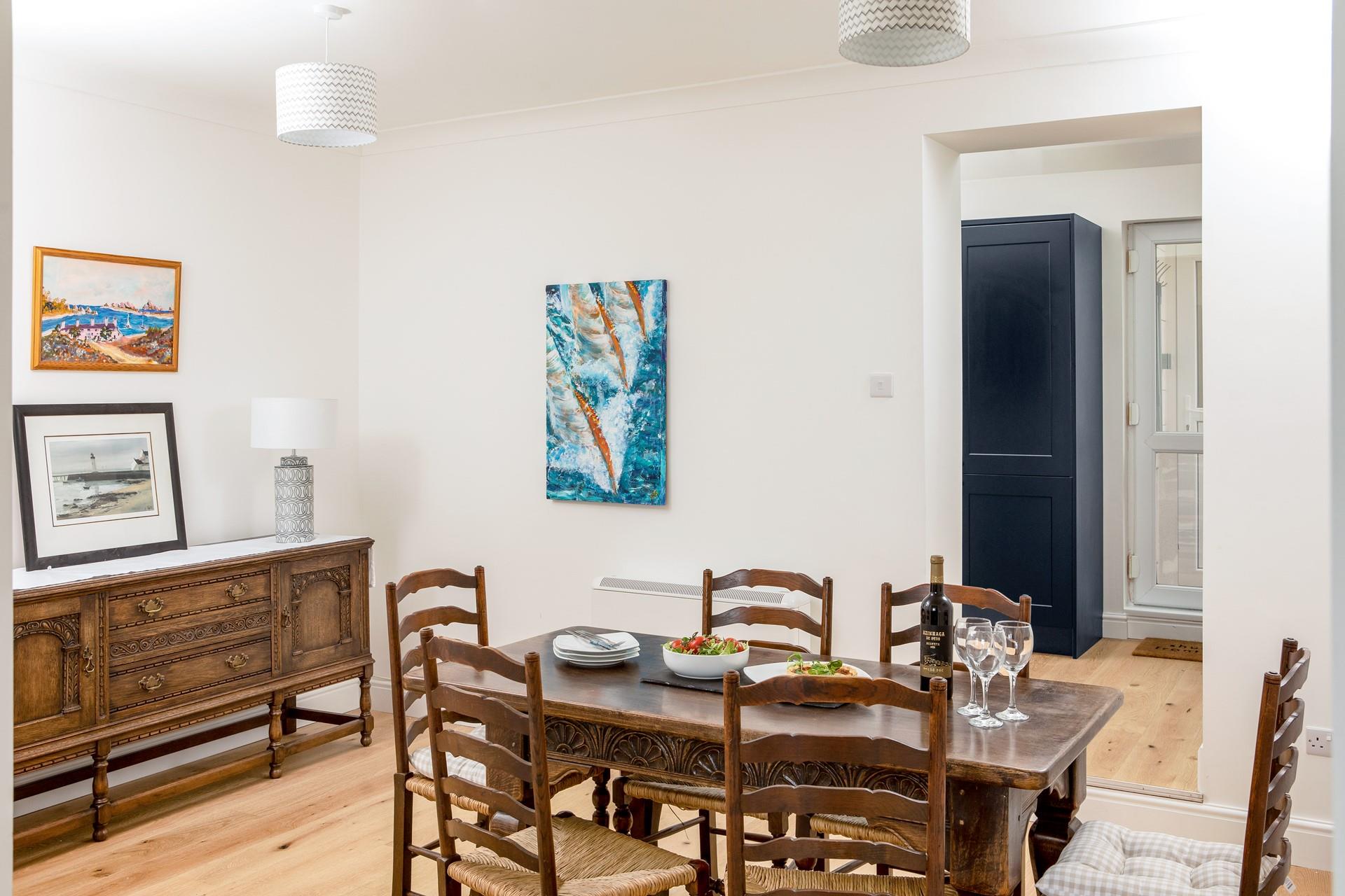 Coastal inspired artwork fills the walls of this home from home.