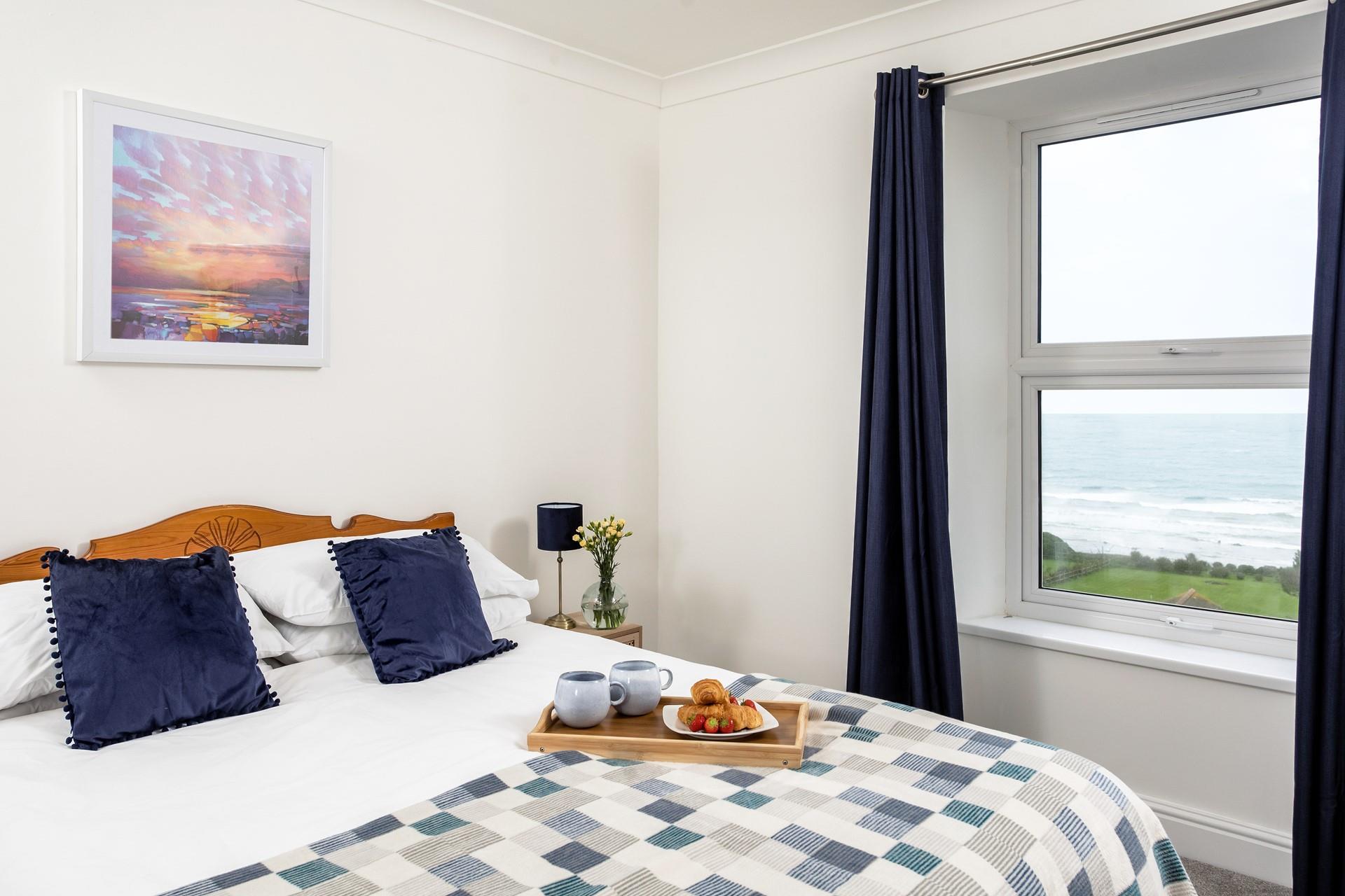 Ocean blue decor creates a calming space to relax in bedroom 1.