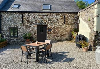 A traditional barn with a lovely outdoor spot, perfect for alfresco dining.