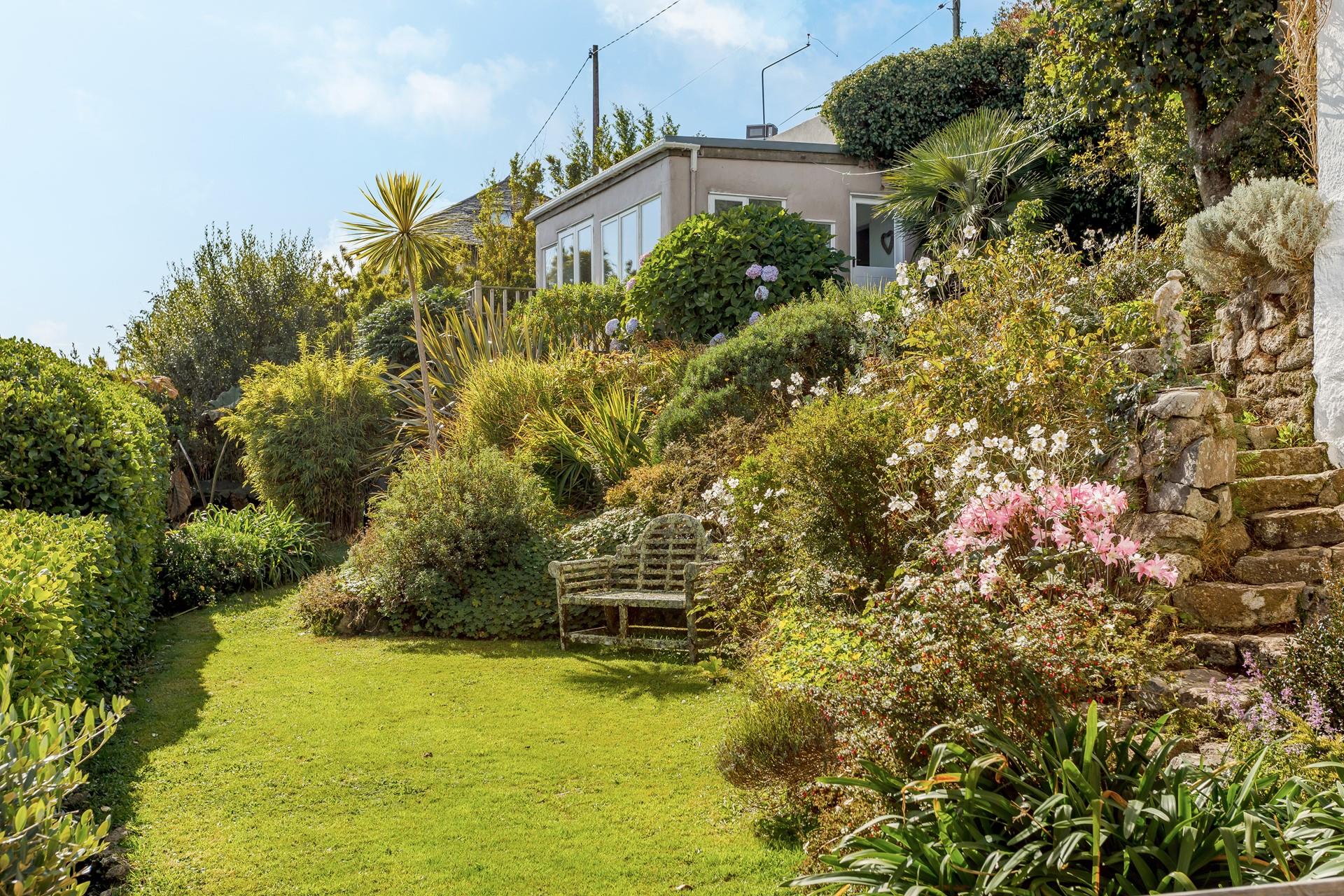 Sit and soak up the sun in the flower-filled garden.