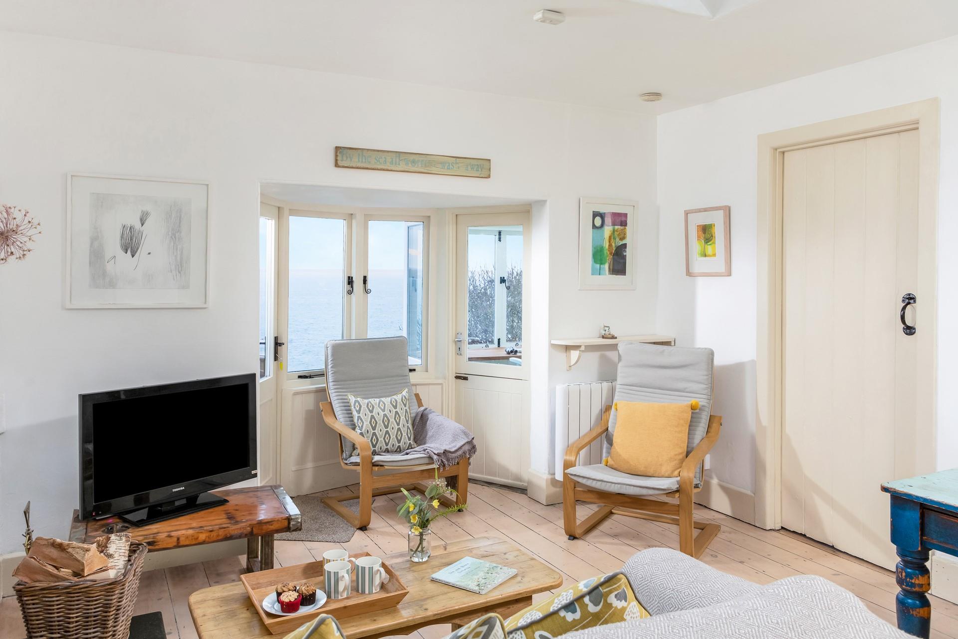 Tuck into tea and cake in the sitting room after a morning spent walking the coast path.