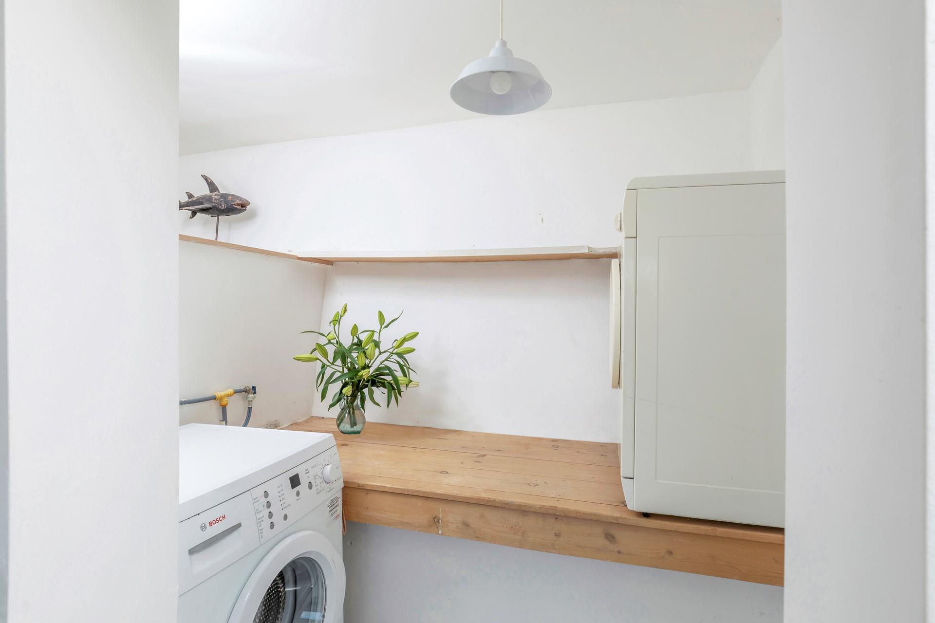 The utility area is handy for washing and drying clothes.