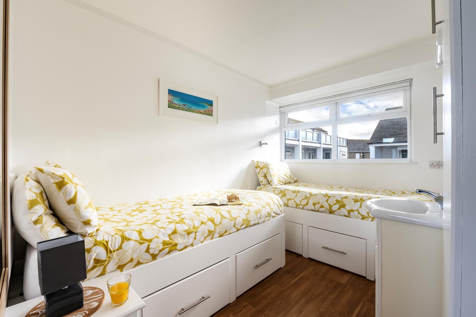 Bedroom 1 has twin beds with handy under-bed storage space.