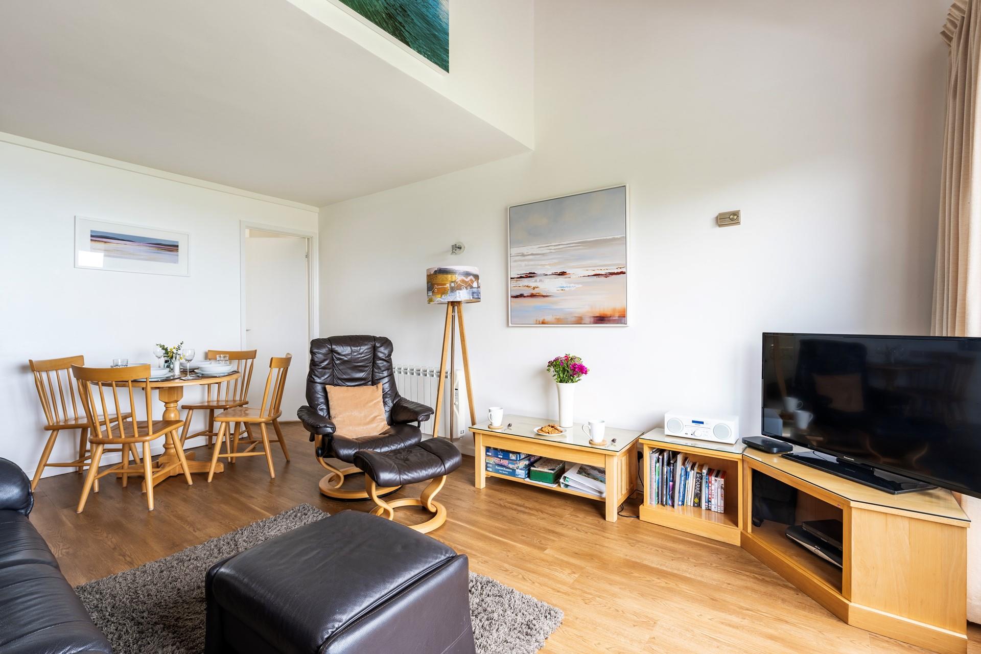 Contemporary art and furnishings fill the cosy sitting room space.