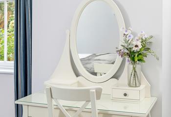 Get ready for the day at the lovely dressing table.